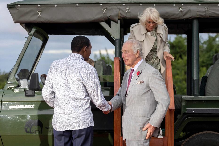 Britain's King Charles III (C) and Britain's Queen Camilla (back) arrive to meet Kenyan Cabinet Secretary for Tourism and Wildlife Albert Mutua (L) at Nairobi National Park�s ivory burning site, an historic location where 12 tonnes of ivory were burnt by the former Kenyan President Daniel Arap Moi in 1989, in Nairobi on November 1, 2023. (Photo by Luis Tato / AFP)